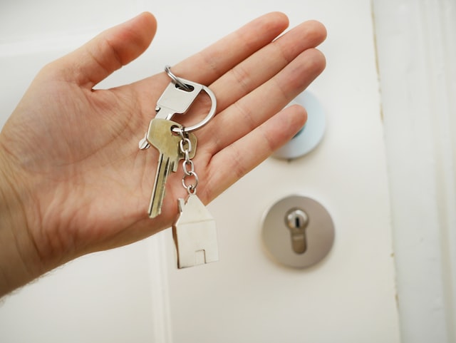 hand holding keys with home keychain